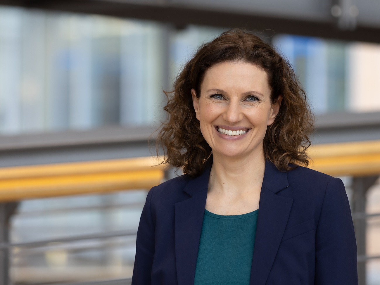 Mitarbeiterin lächelt in die Kamera.