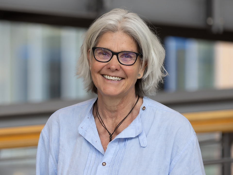 Mitarbeiterin lächelt in die Kamera.